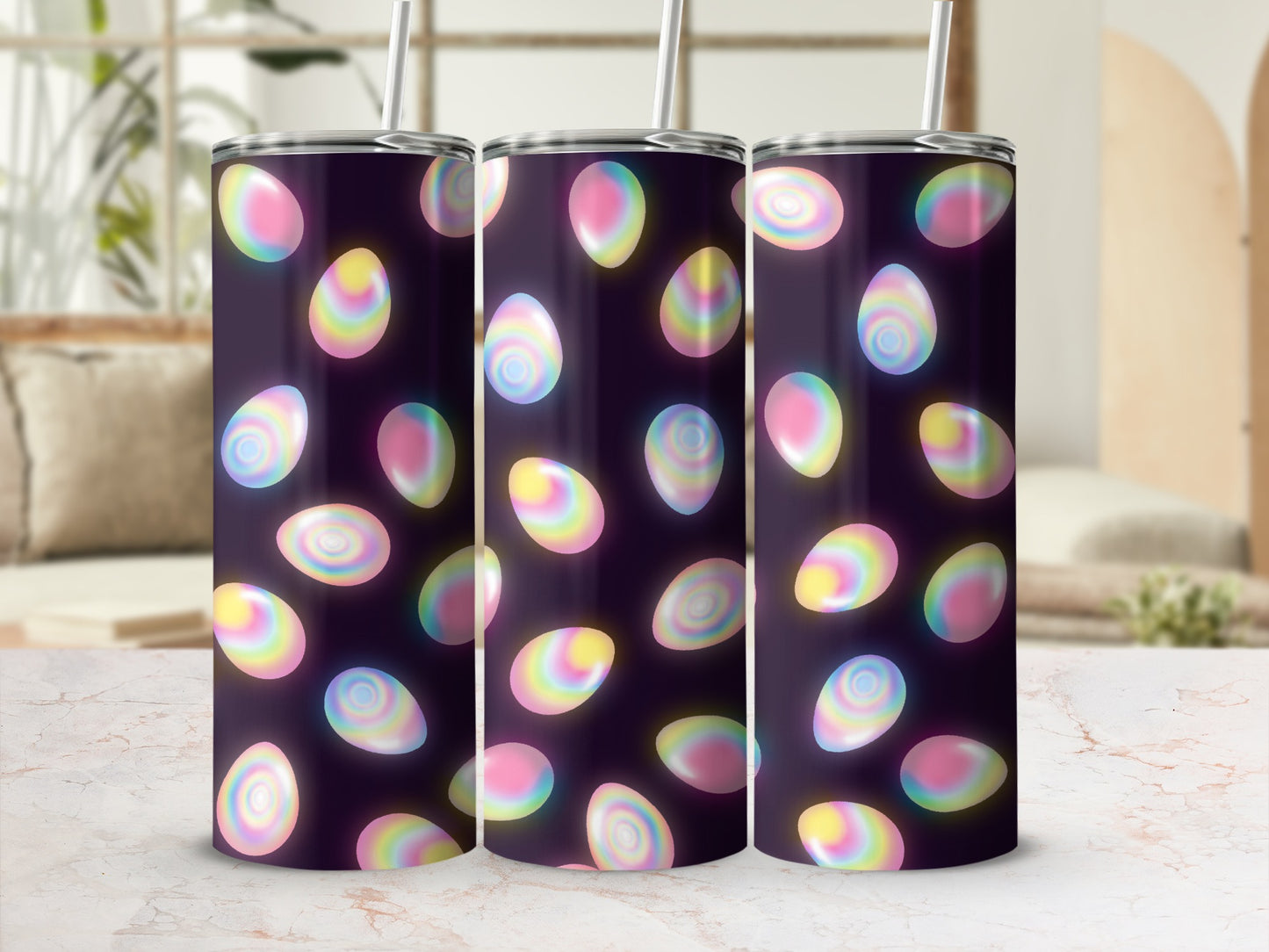 Three tumblers with a pastel Easter egg pattern and straws.