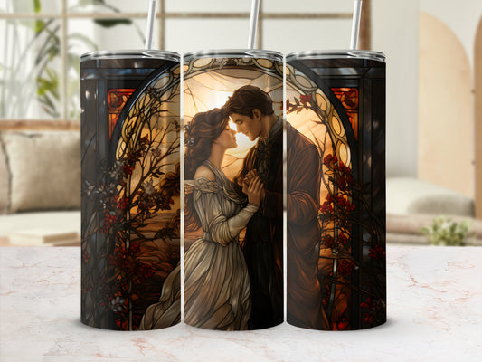 Couple in wedding attire embracing in front of stained glass window.