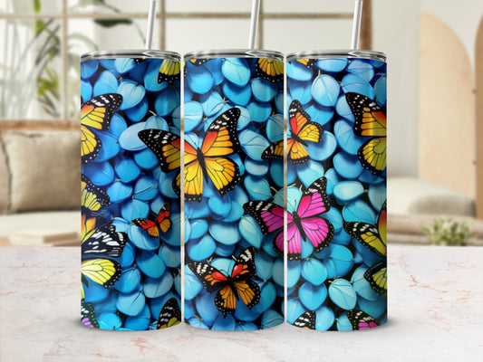 Three tumblers with a vibrant butterfly and blue pebble pattern.