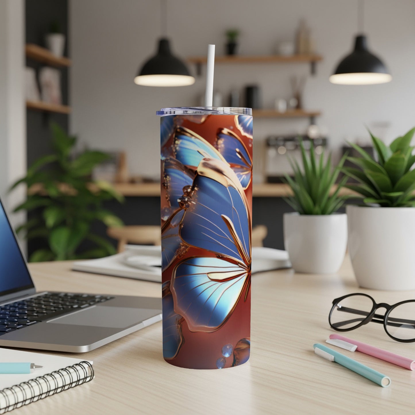 Blue butterfly design on a stainless steel tumbler with straw.