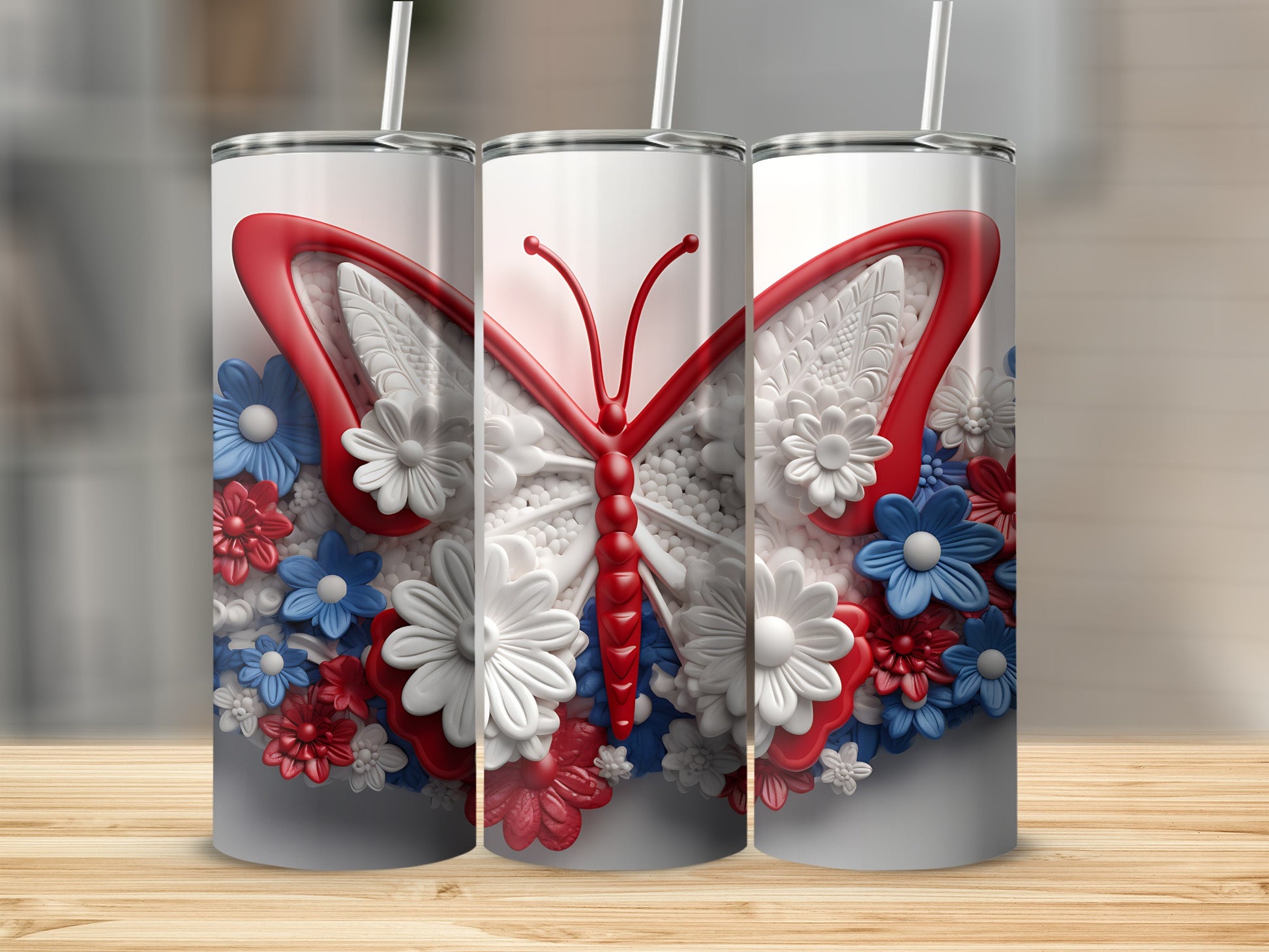 Three tumblers with butterfly and floral designs in red, white, and blue.