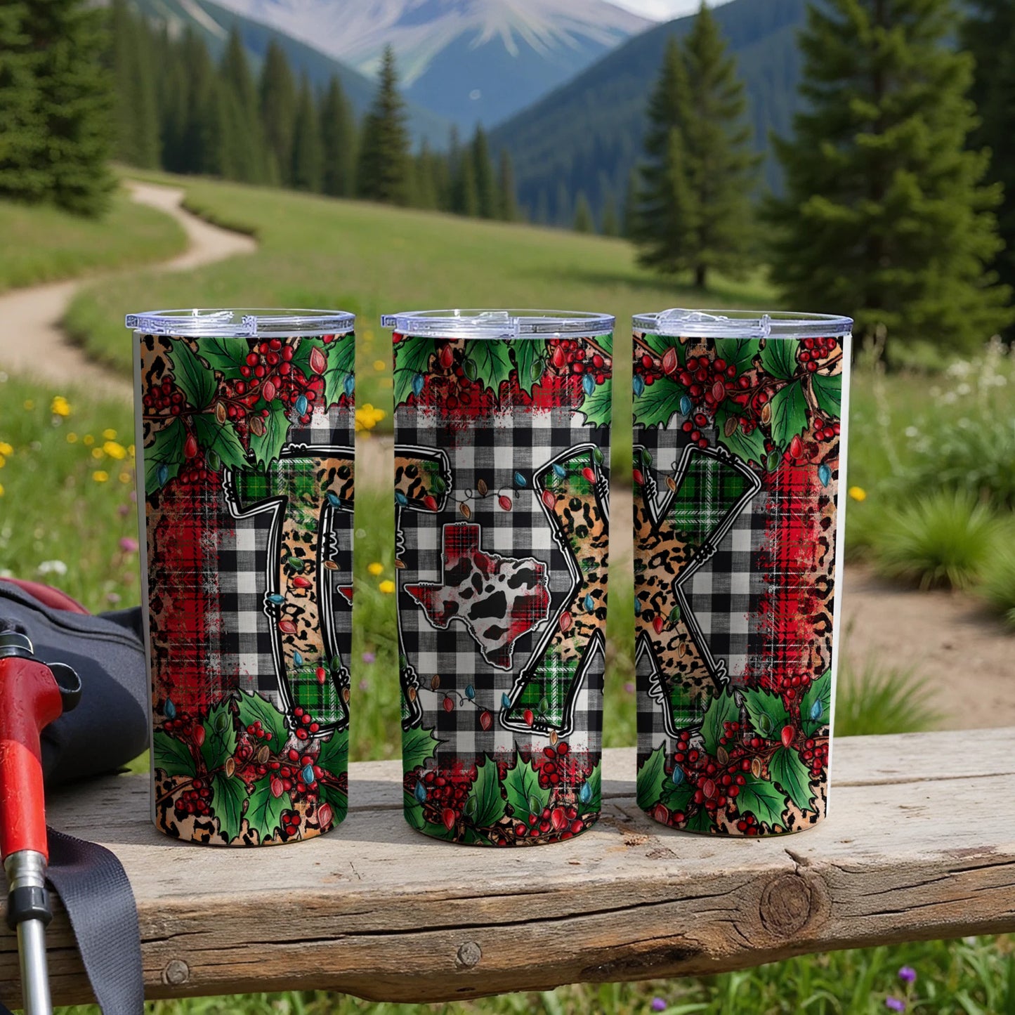 Three tumblers with Christmas designs, including buffalo plaid and holly berries.