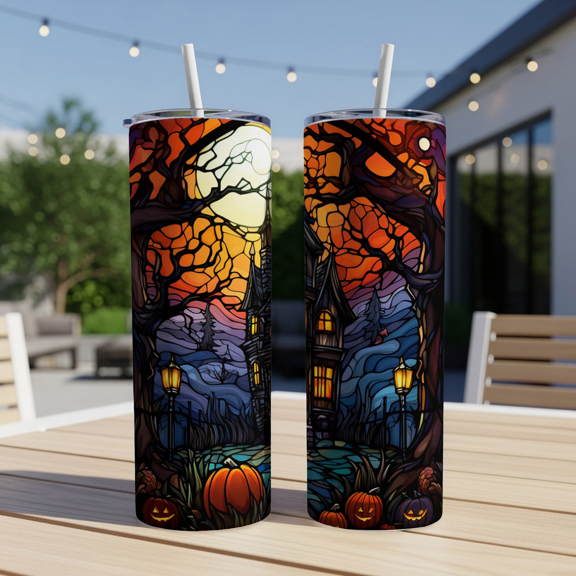 Two Halloween-themed tumblers with spooky haunted house and pumpkin designs.