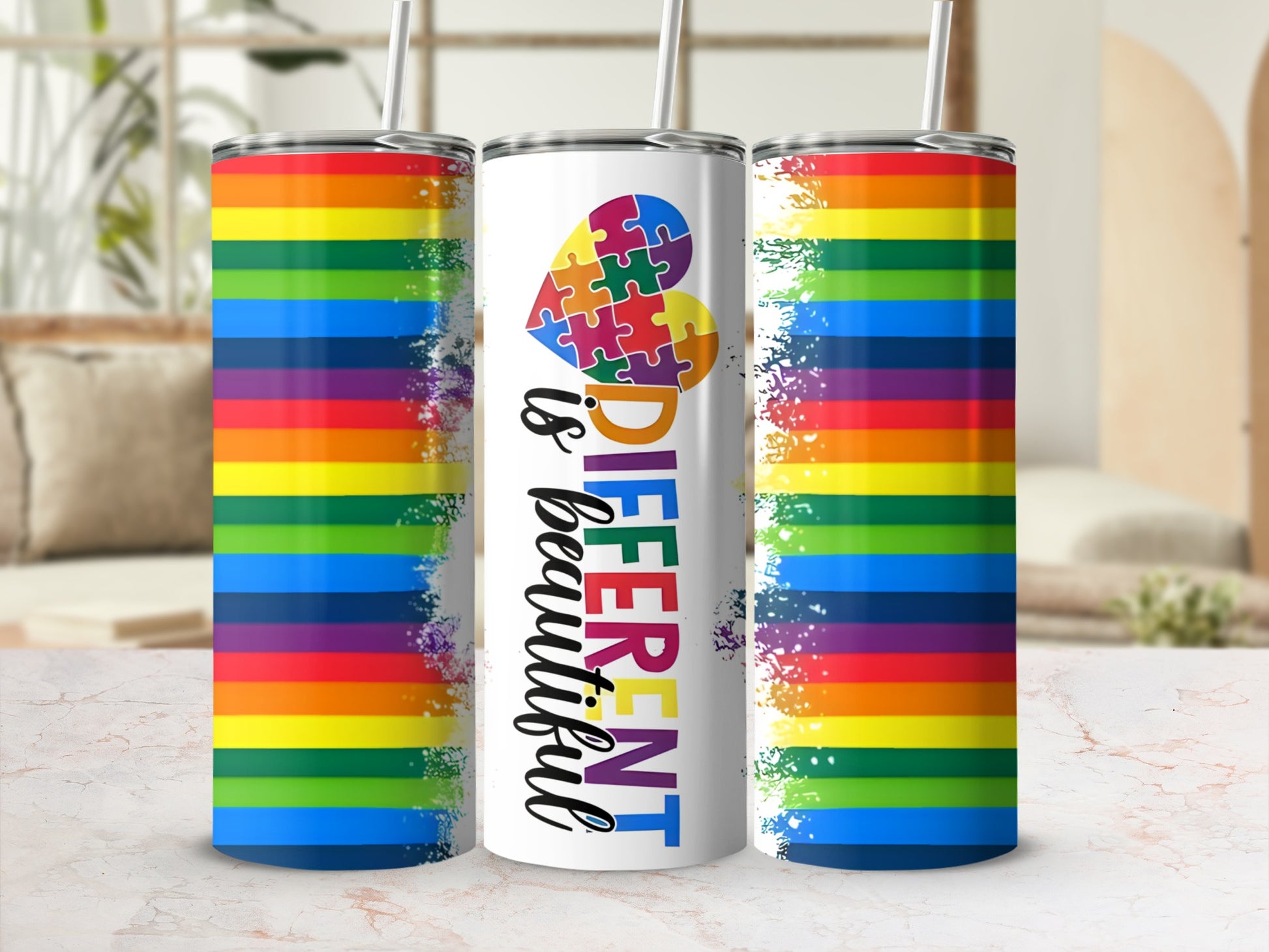 Rainbow tumbler with "Different is Beautiful" text and puzzle heart.