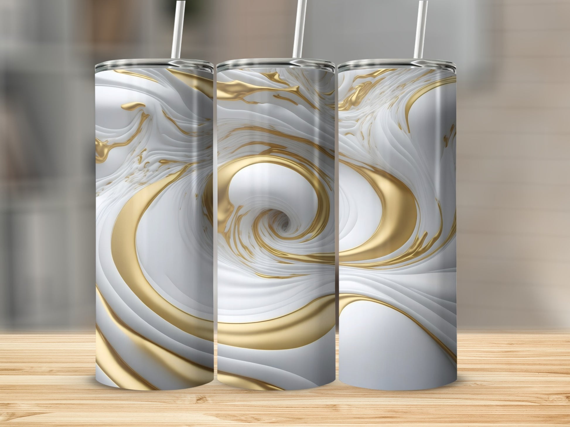 Three white and gold marbled tumblers with straws on a wooden surface.