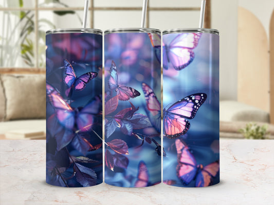 Three tumblers with purple and pink butterflies on dark leaves.