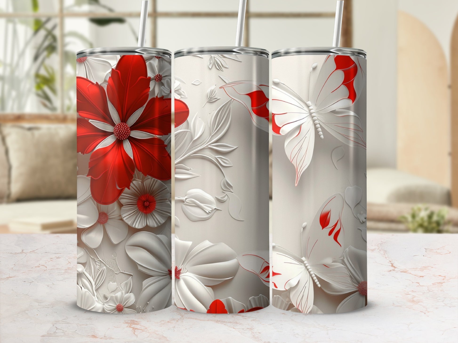 Three floral and butterfly patterned tumblers with red accents.
