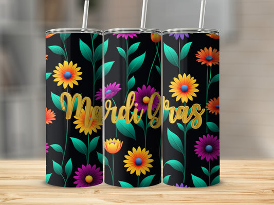 Three Mardi Gras tumblers with floral designs stand on a wooden surface.