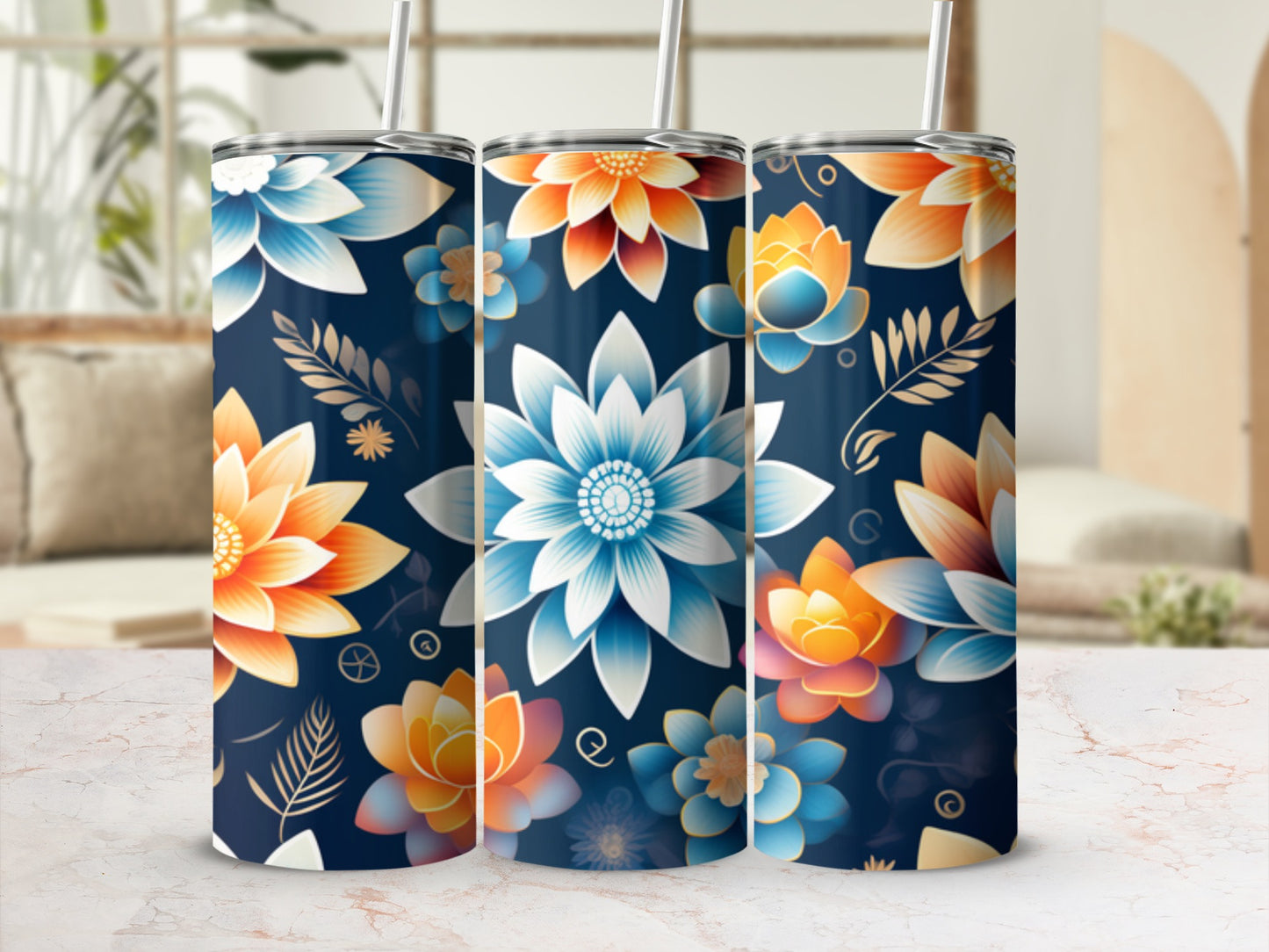 Three floral tumblers with straws on a marble surface.