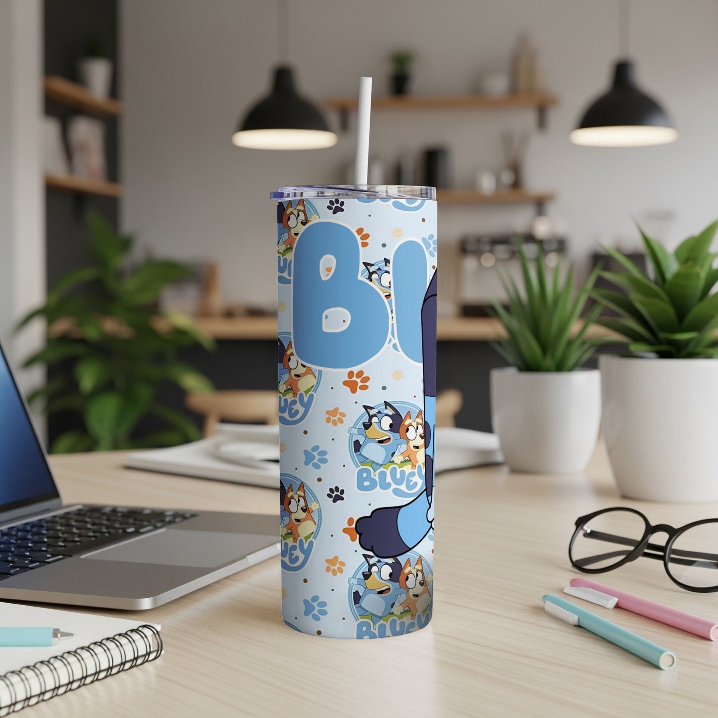 Bluey character tumbler with blue background and cartoon dogs.