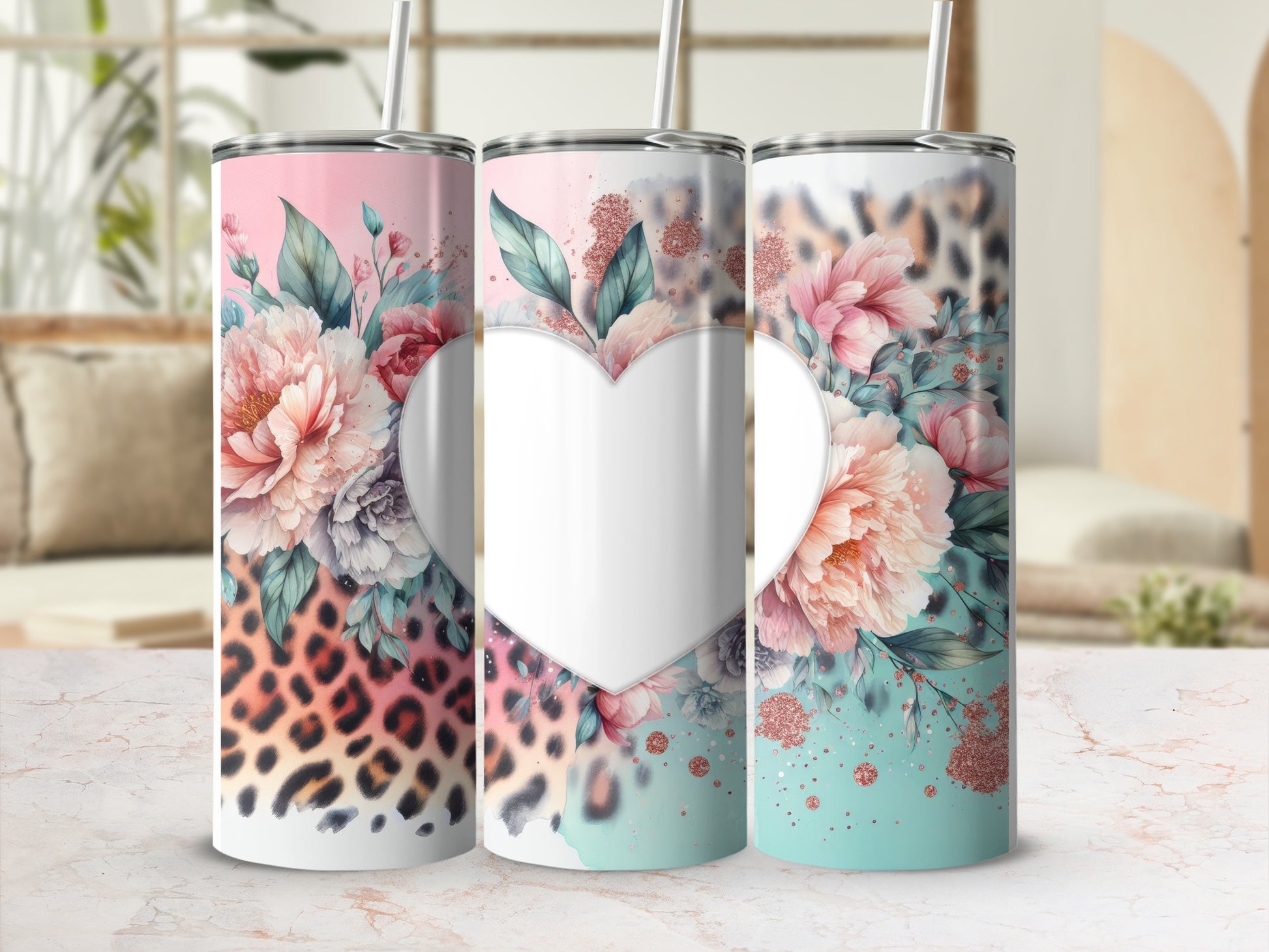 Three tumblers with floral and leopard print designs and a heart in the center.