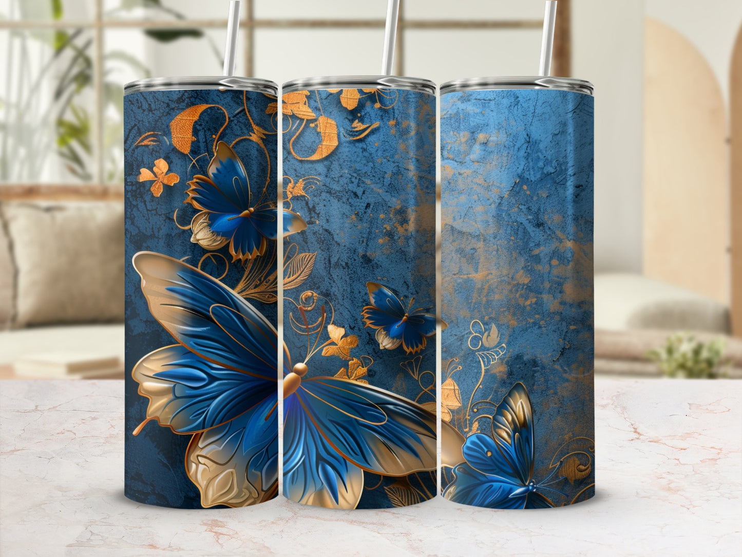 Blue and gold butterfly pattern on three tumblers with straws.