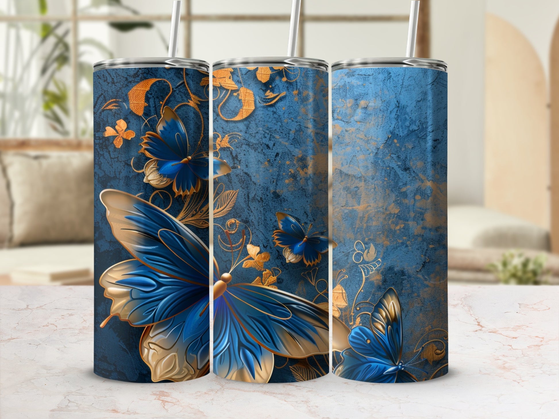 Blue and gold butterfly pattern on three tumblers with straws.