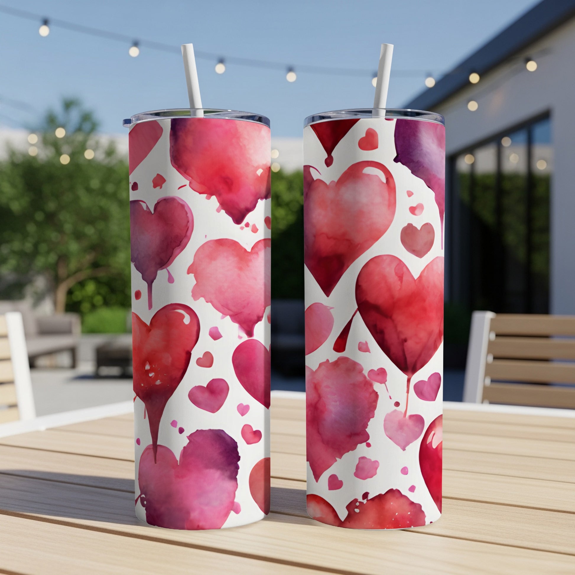 Two tumblers with a repeating pattern of watercolor red and pink hearts.