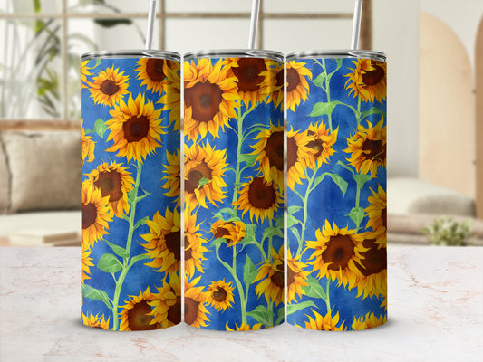 Blue tumbler with a repeating pattern of yellow sunflowers and green leaves.