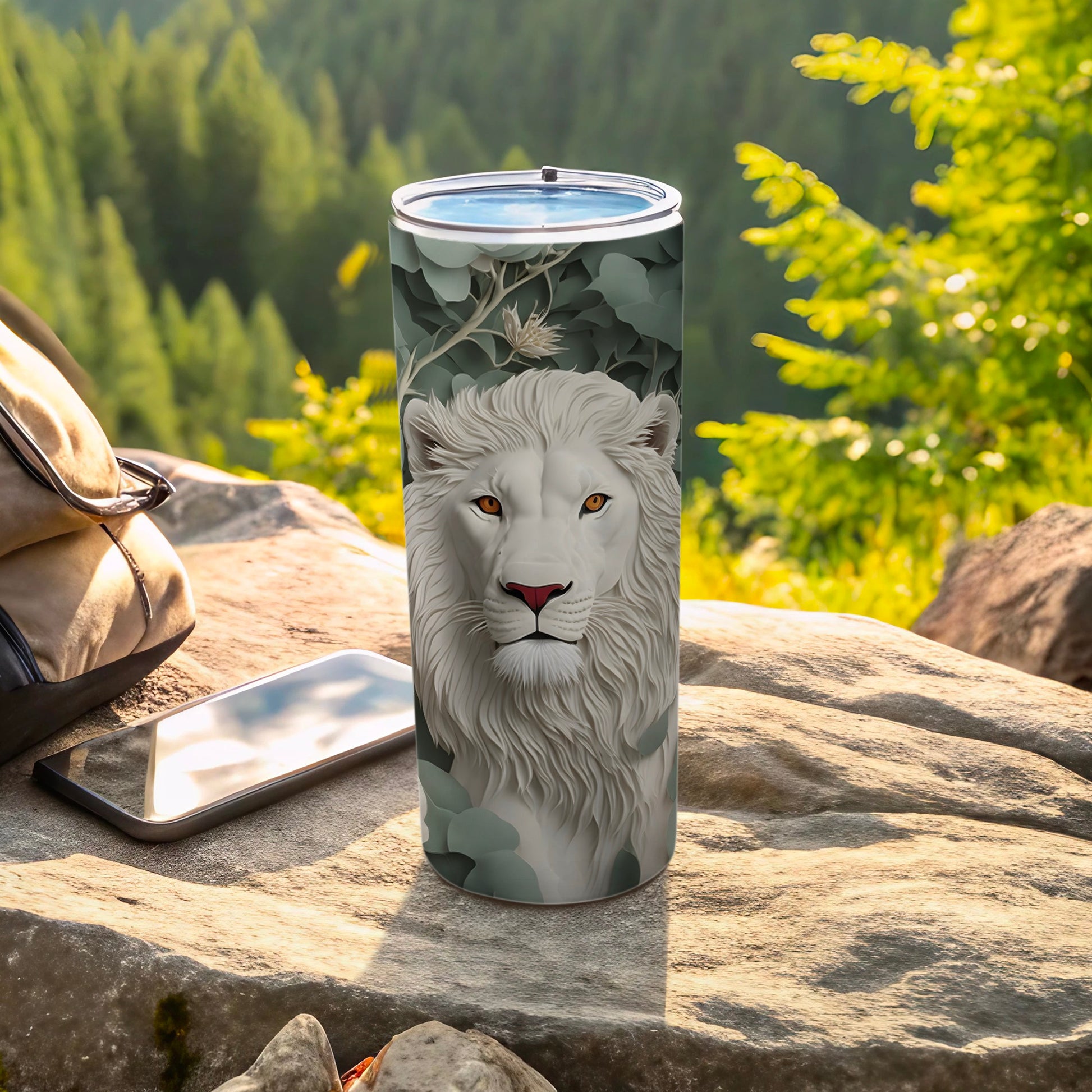 White lion design on a tumbler with a phone and backpack.
