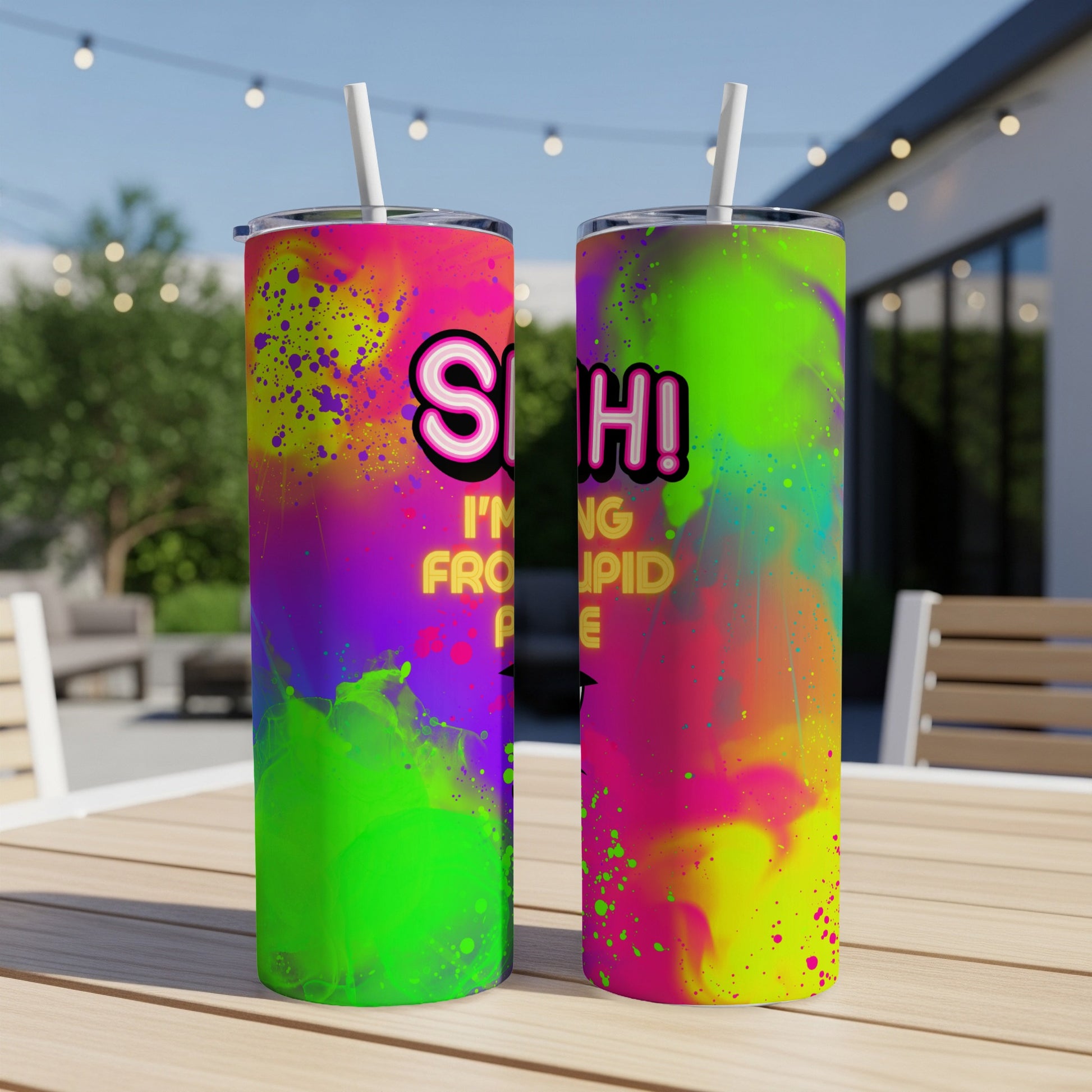 Tumbler with neon paint splatter and "Shhh! I'm from stupid people" text.
