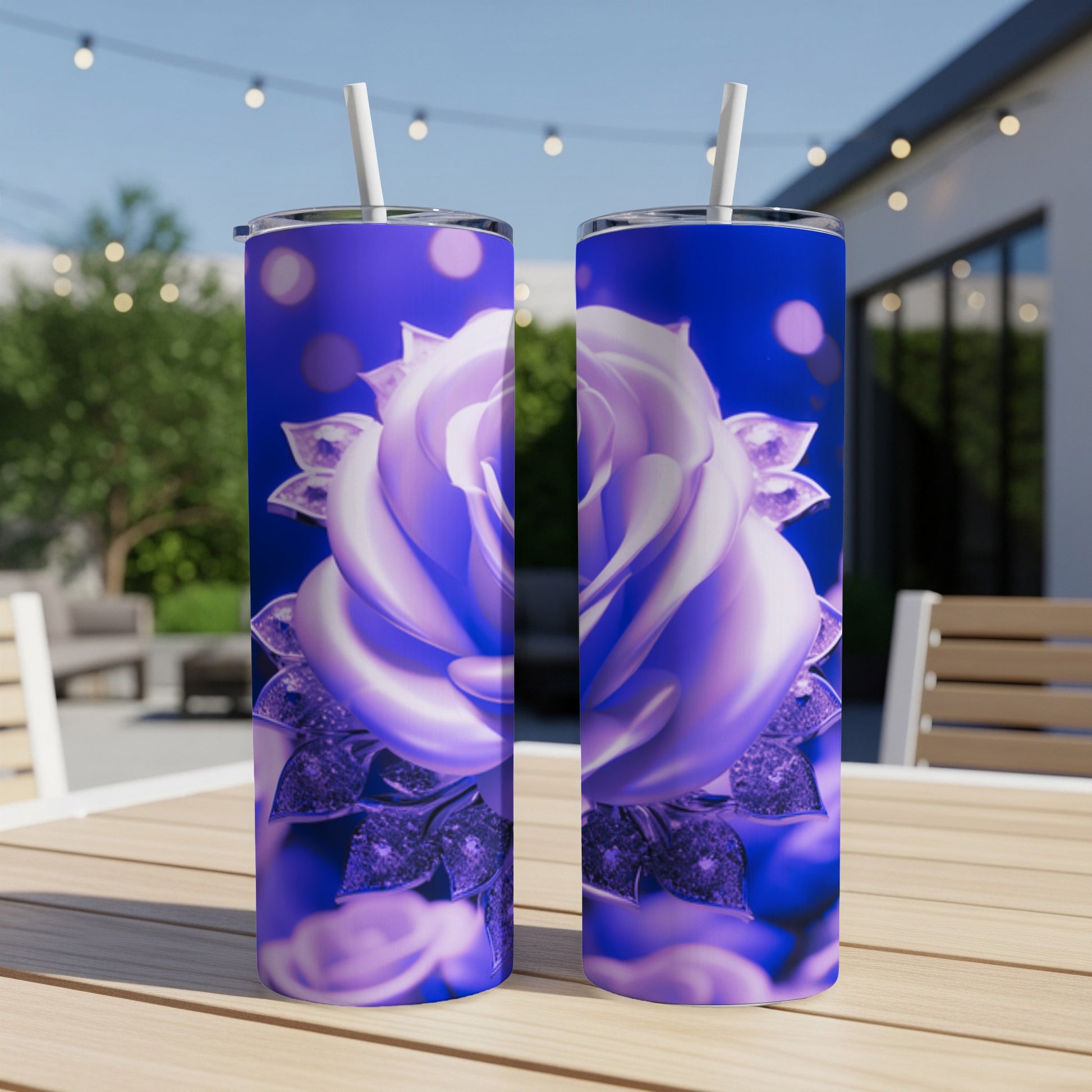 Two blue iridescent rose tumblers on a wooden table outdoors.