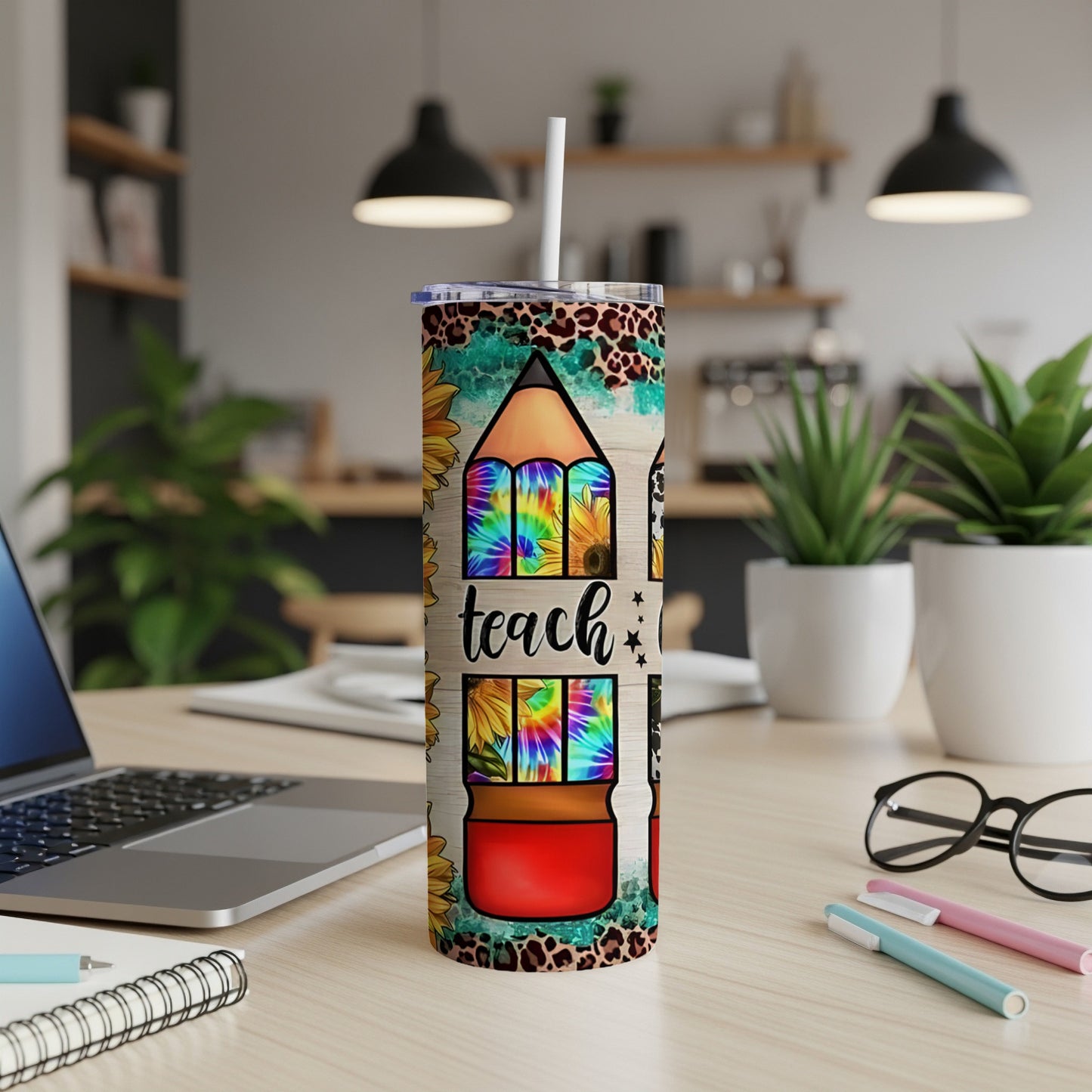 Tall tumbler with tie-dye sunflowers and "teach" text.