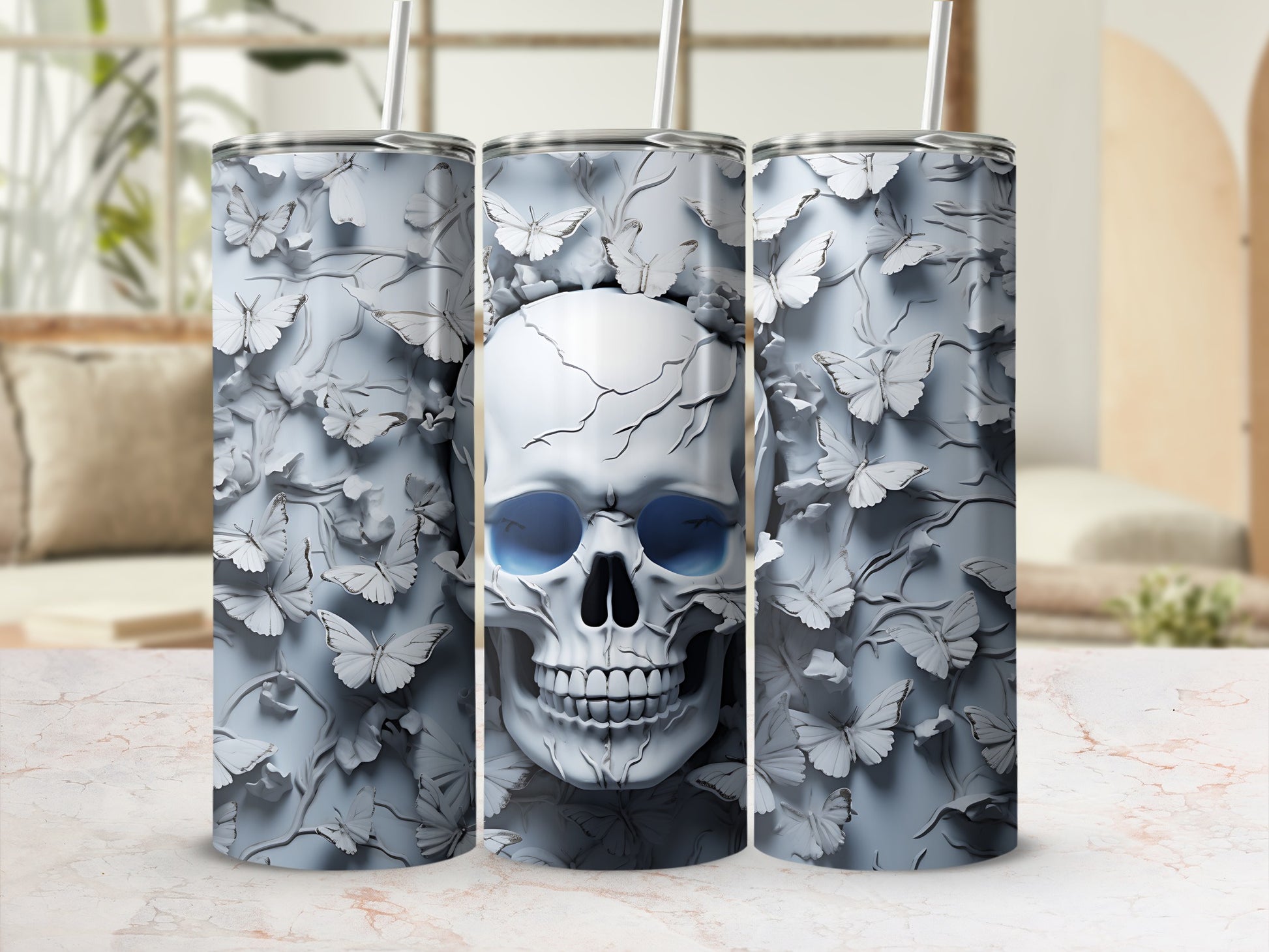 Triptych of white skinny tumblers with a skull and butterfly pattern.