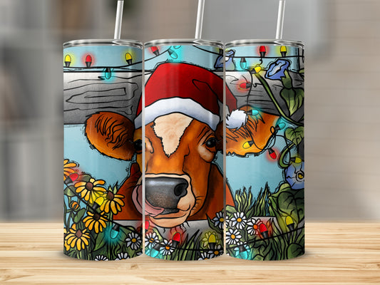 Christmas cow with Santa hat and string lights, surrounded by flowers.
