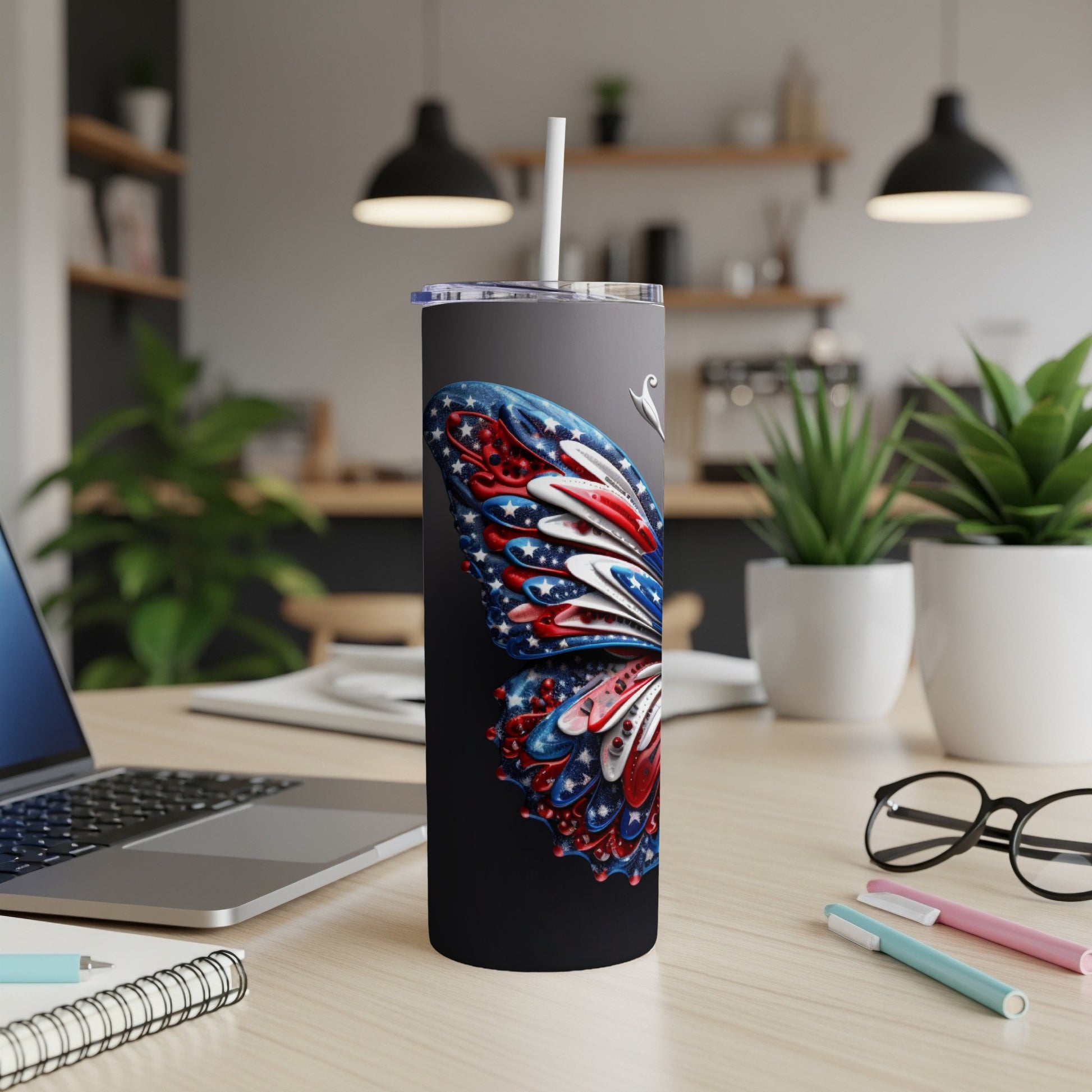 Black tumbler with a patriotic butterfly design and white straw.