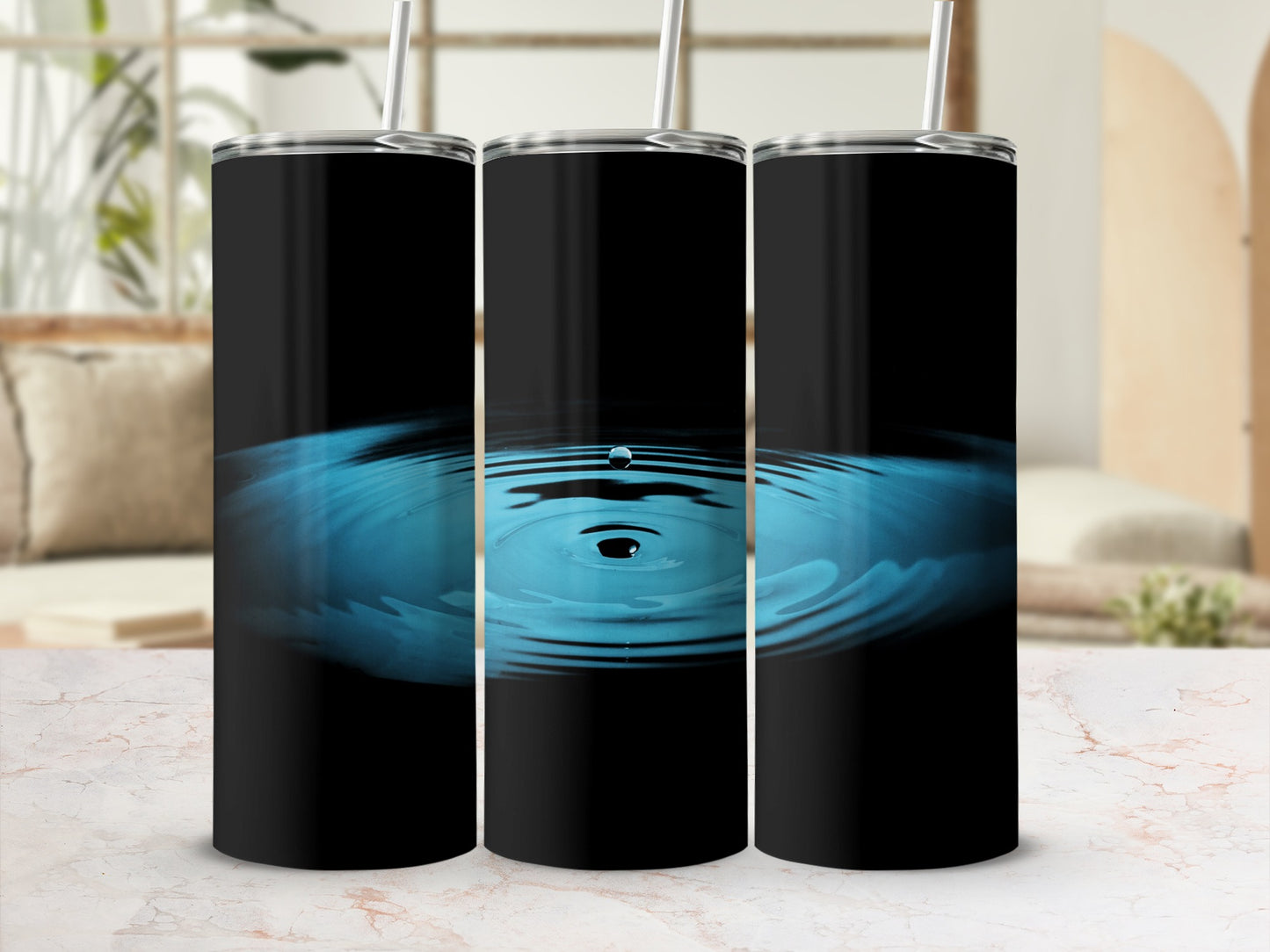 Three black tumblers with ripples on a marbled surface.