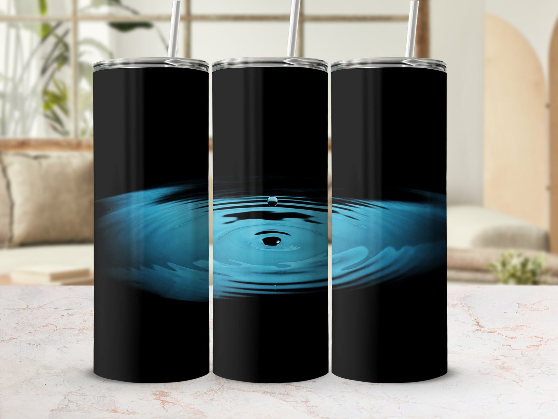 Three black tumblers with ripples on a marbled surface.