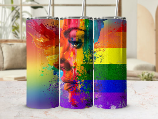 Tumbler with abstract rainbow-splattered portrait of a face.