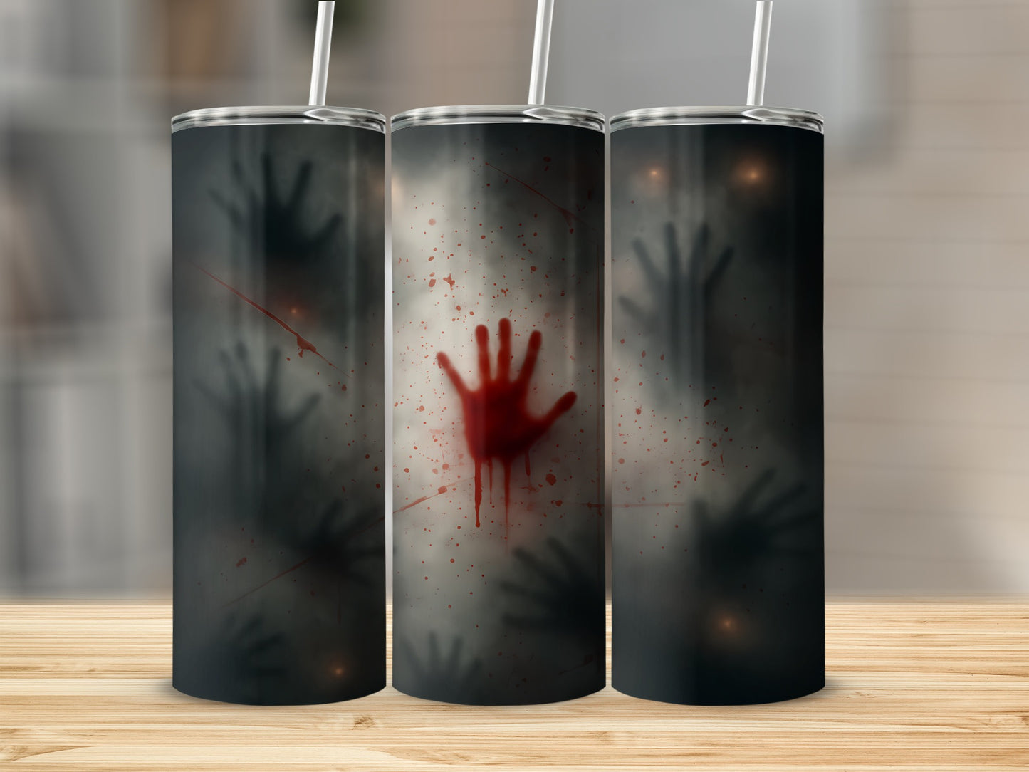 Three tumblers with spooky hand prints and blood splatters on a wooden surface.