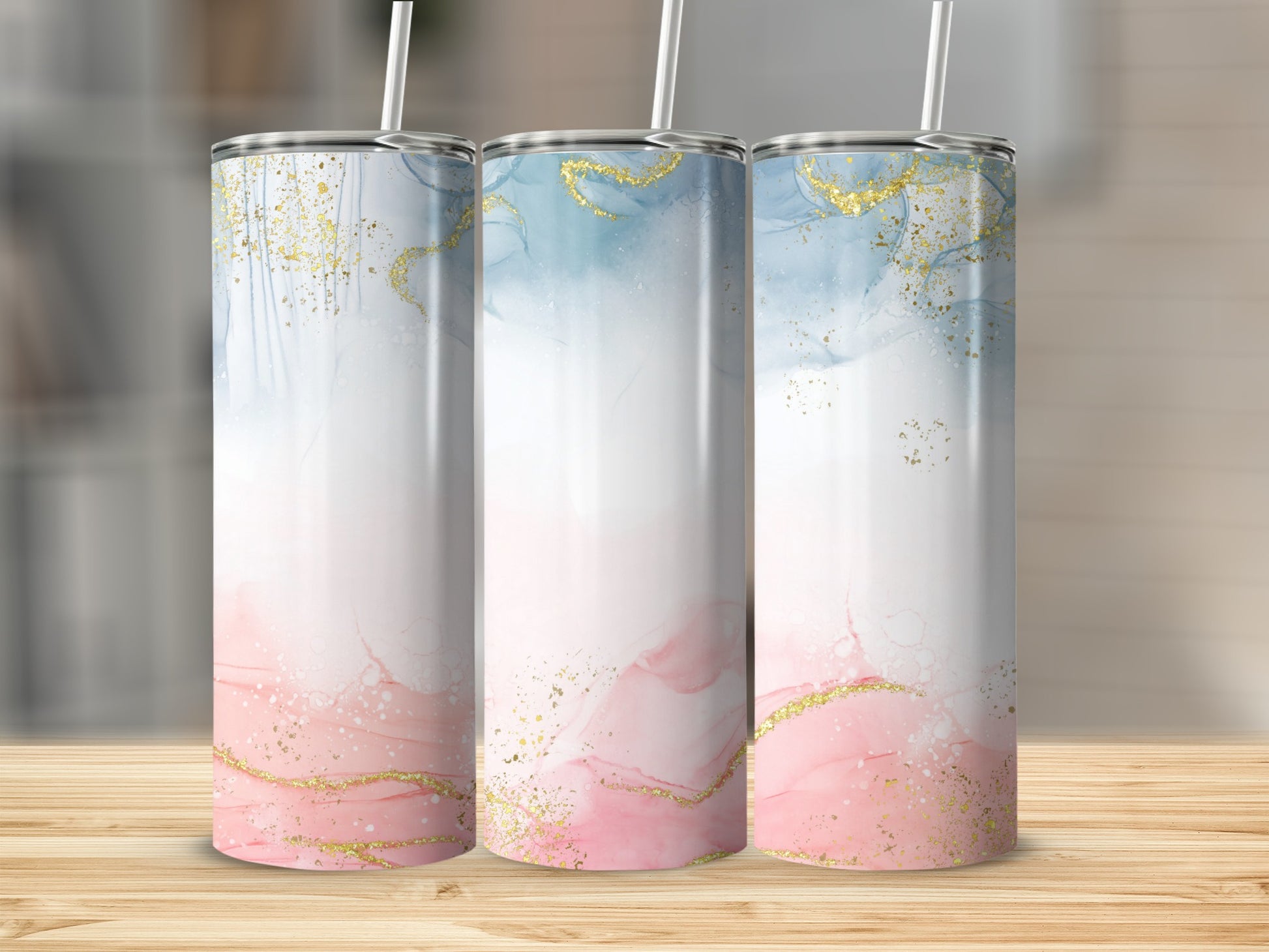 Three tumblers with pink, blue, and gold abstract watercolor designs.