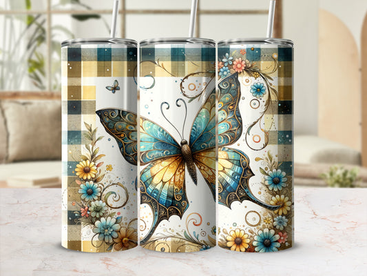 Tall tumbler with a large teal and gold butterfly and floral accents on a checkered background.