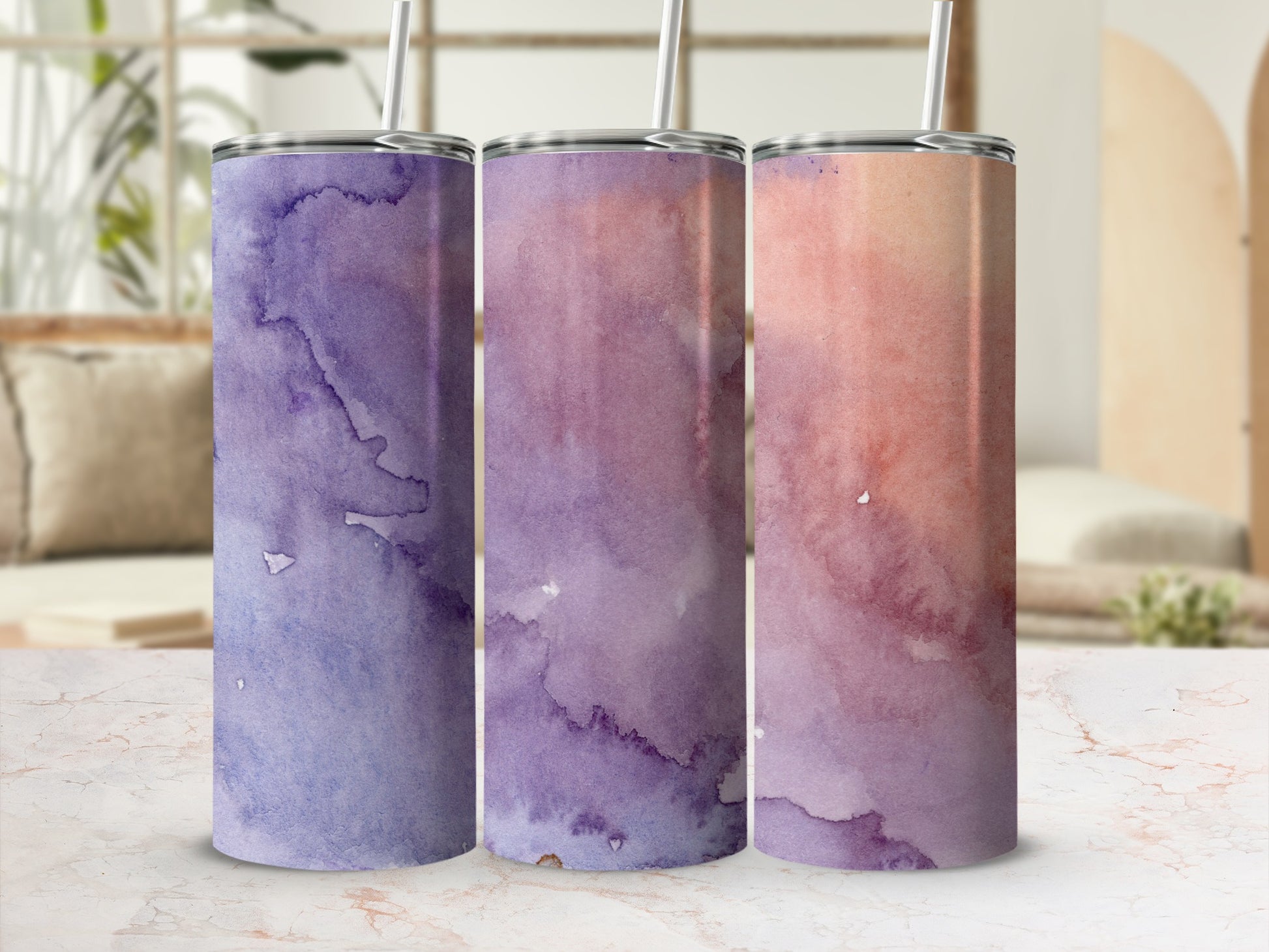 Three tumblers with purple and pink watercolor designs.
