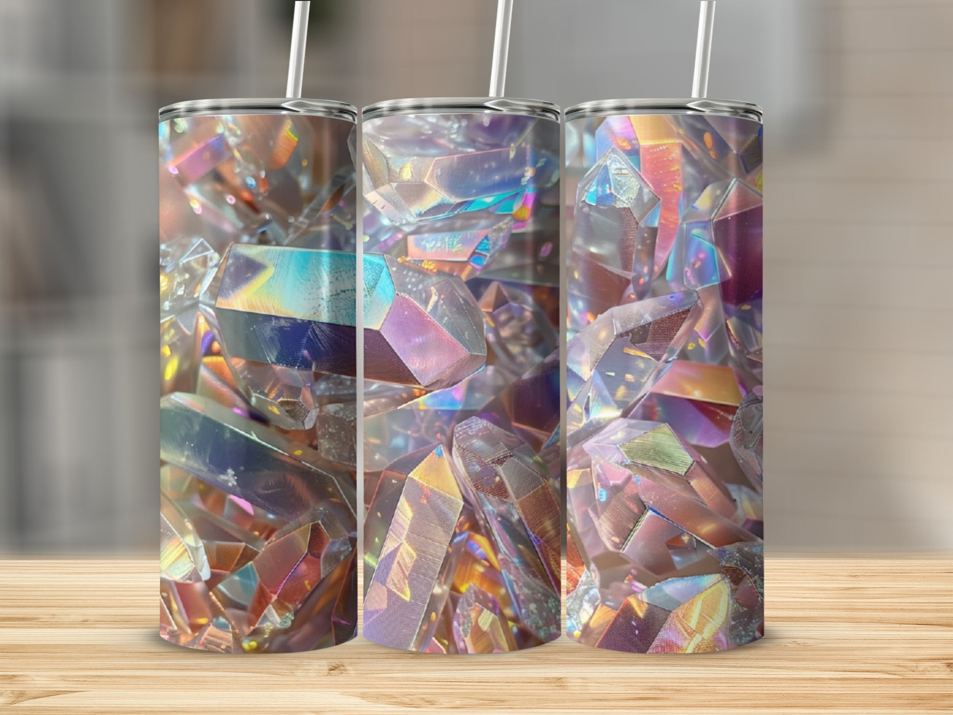 Three tumblers with iridescent crystal patterns on a wooden surface.