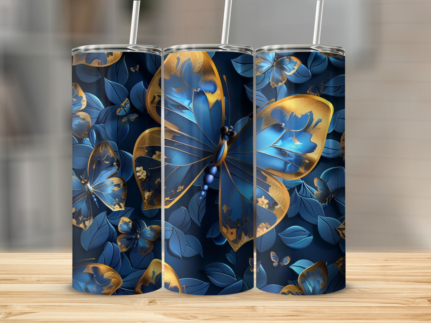 Three tumblers with blue and gold butterfly and floral design.