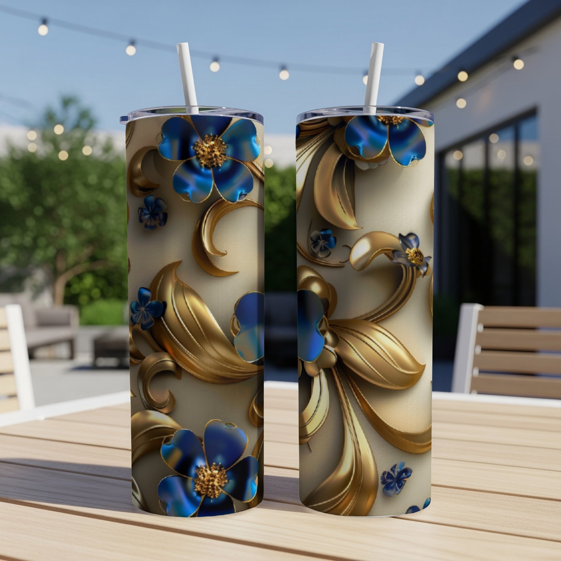 Two tall, insulated tumblers with blue flowers and gold scrolled design.