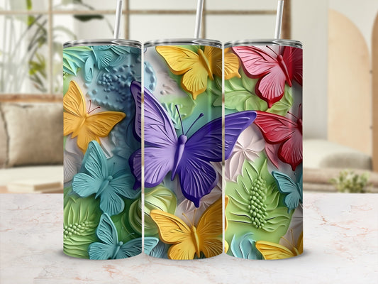 Three colorful butterfly tumblers with textured details and straw lids.