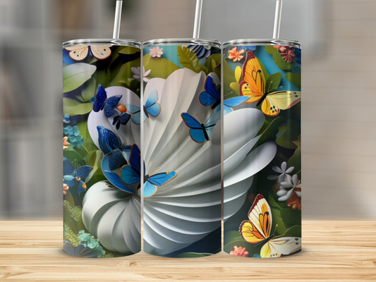 Three patterned tumblers with butterflies and floral designs sit on a wooden surface.