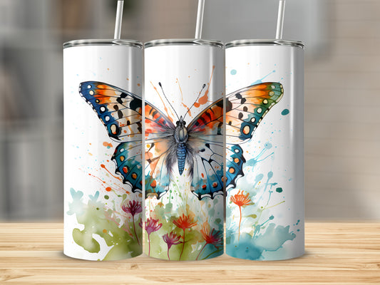 Three tumblers with watercolor butterfly and floral designs on a wooden surface.