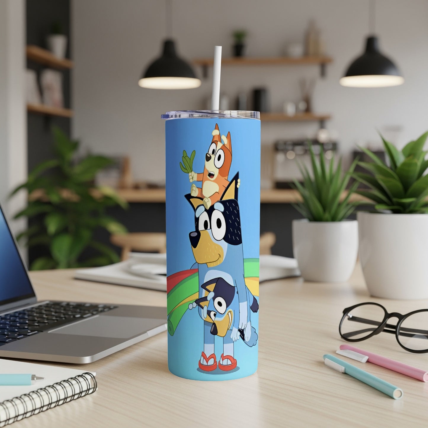 Bluey and Bingo characters on a blue tumbler.