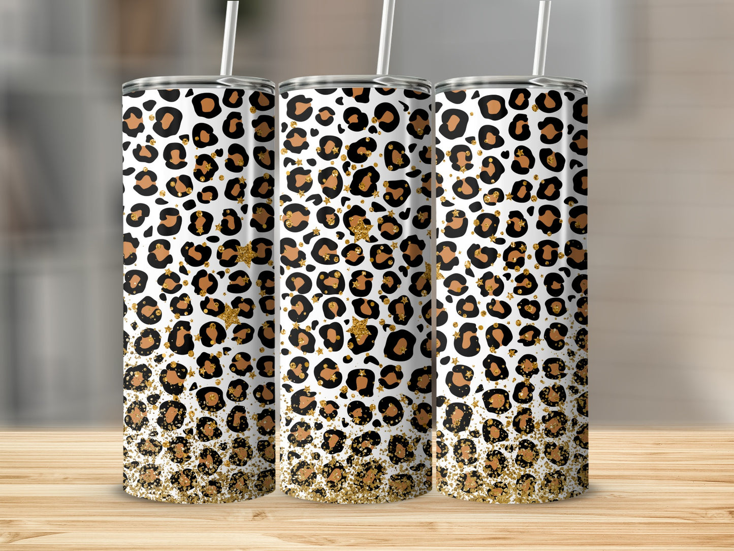 Three skinny tumblers with leopard print and gold glitter designs.