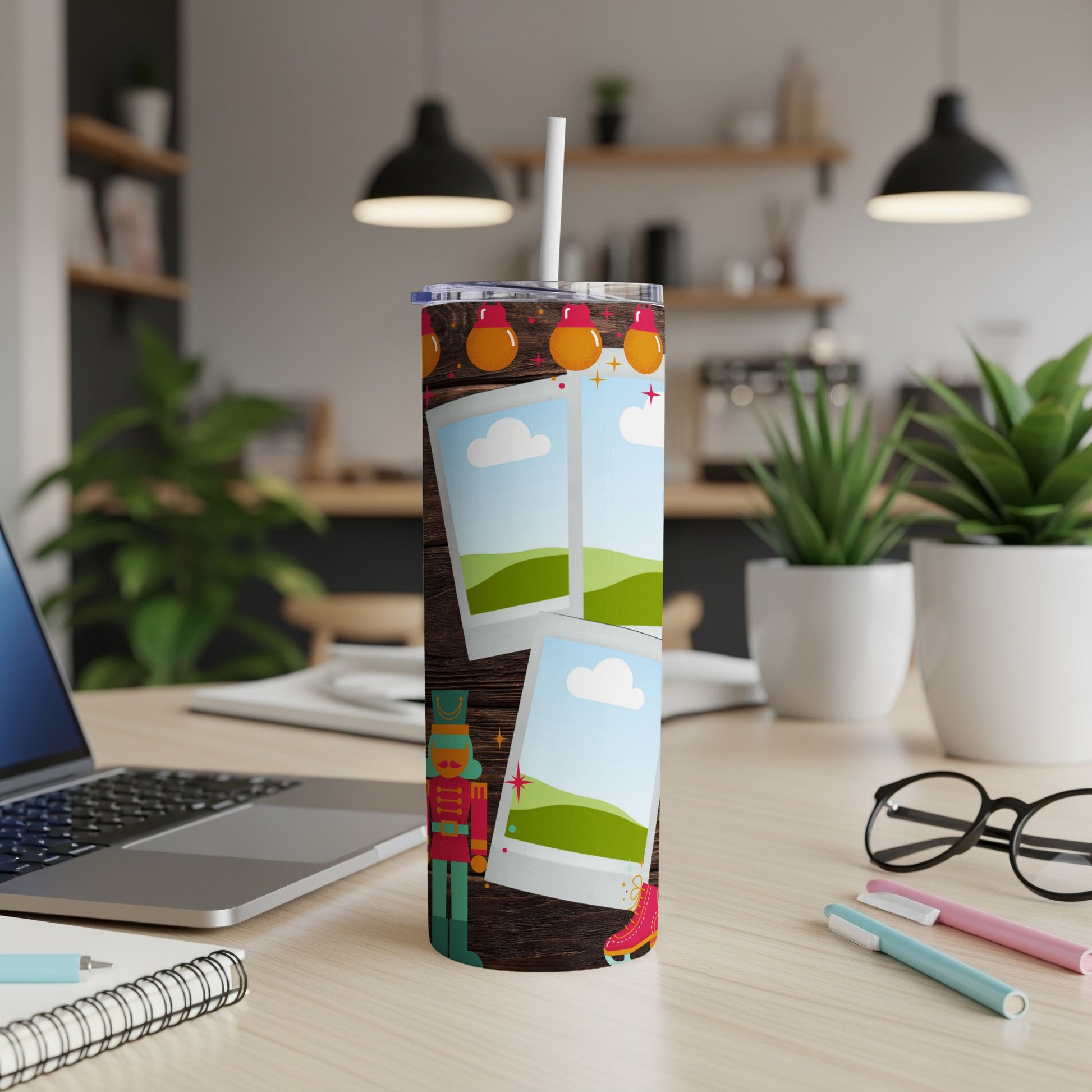 Nutcracker, skates, and photo frames decorate a tumbler with a straw.