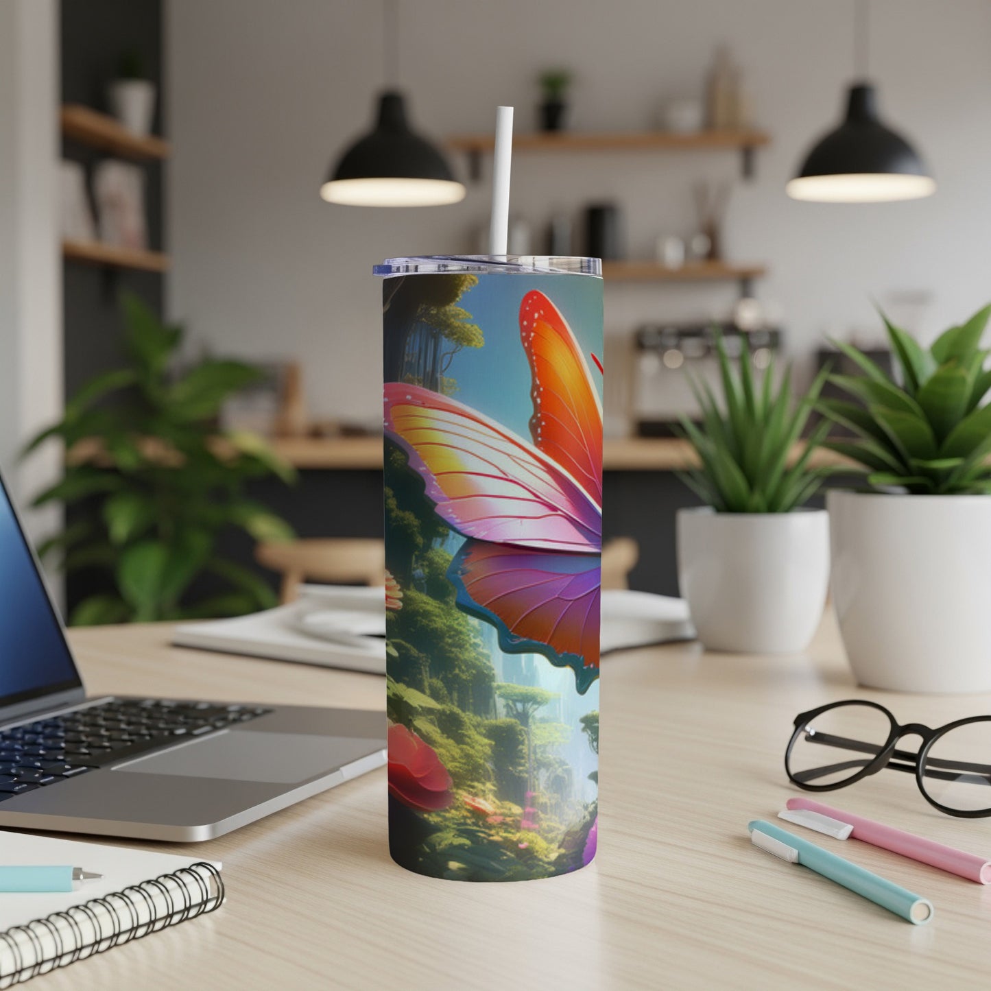 Tumbler with a vibrant butterfly and forest scene on a desk.
