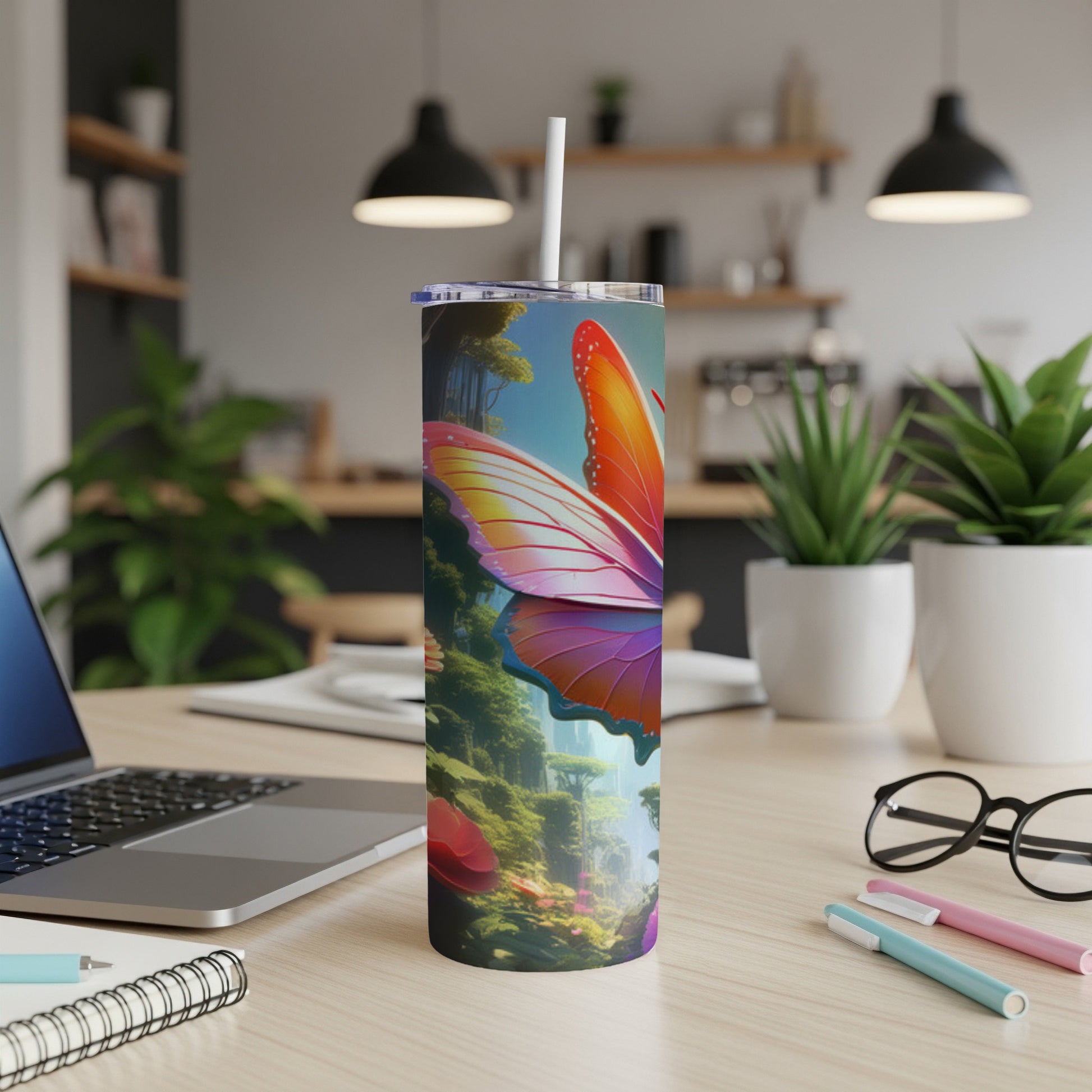Tumbler with a vibrant butterfly and forest scene on a desk.