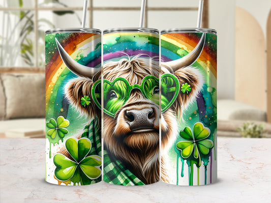 Highland cow wearing heart-shaped sunglasses with shamrocks and rainbow background.