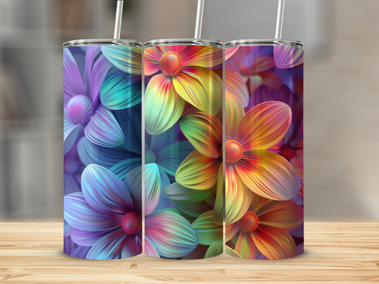 Three colorful floral tumblers with straws on a wooden surface.