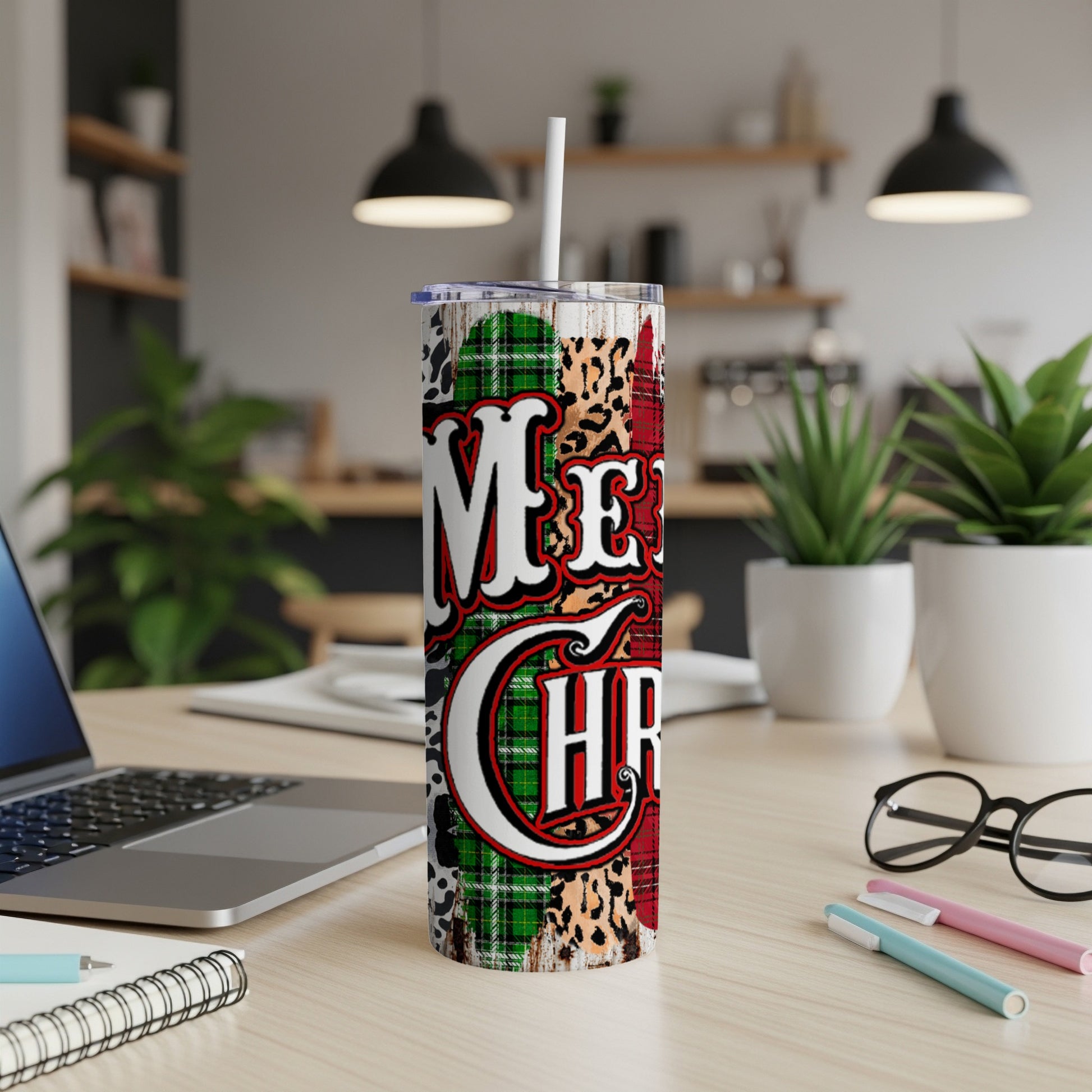 Tall tumbler with "Merry Chr" text on plaid and leopard print background.