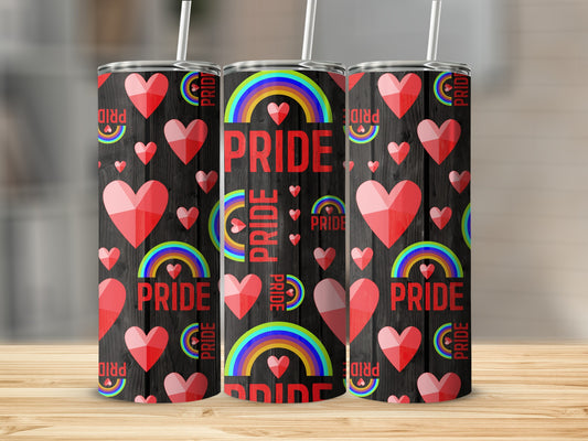 Three pride-themed tumblers with hearts and rainbows on a dark wood background.