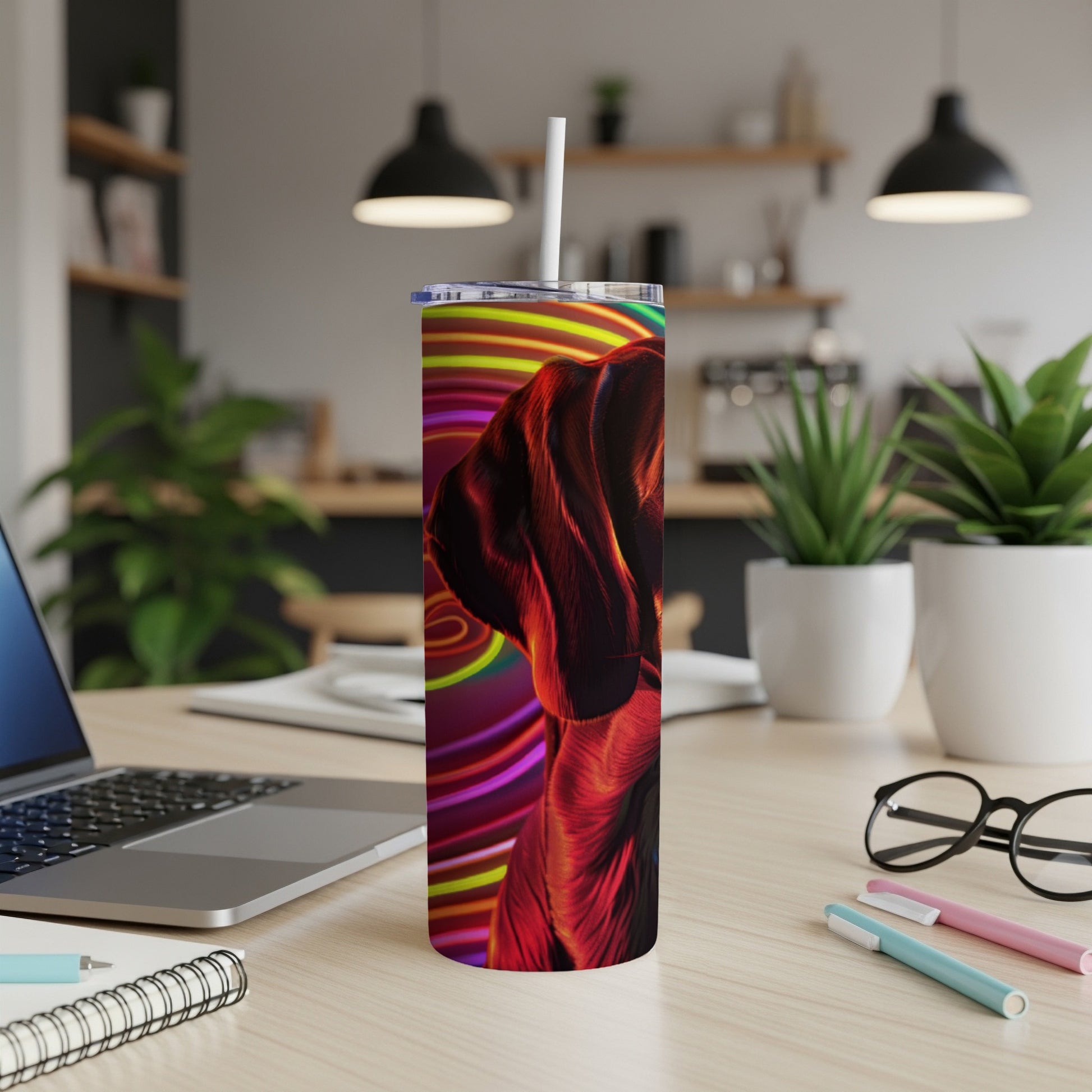 Black and tan dog on a colorful, striped tumbler with a white straw.