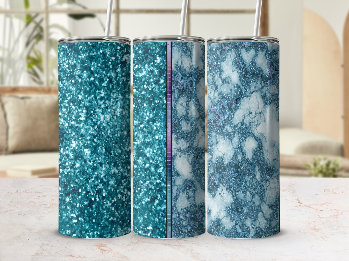 Three glitter and marble pattern tumblers with straws, displayed on a table.